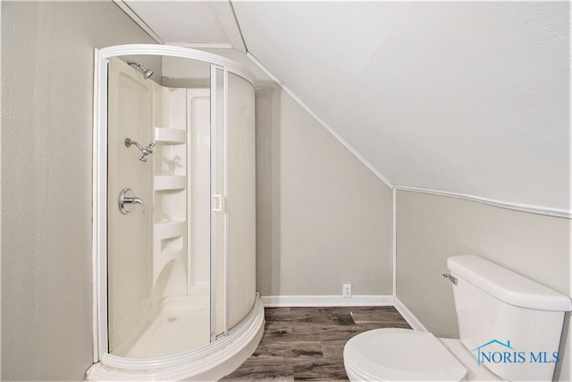 bathroom featuring hardwood / wood-style floors, vaulted ceiling, toilet, and walk in shower