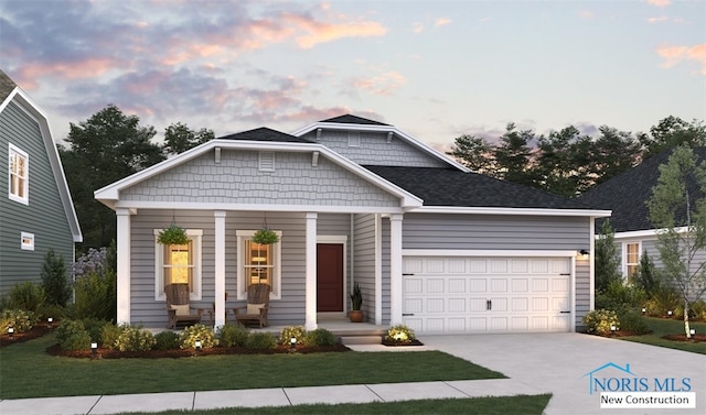 view of front of property with a yard and a garage