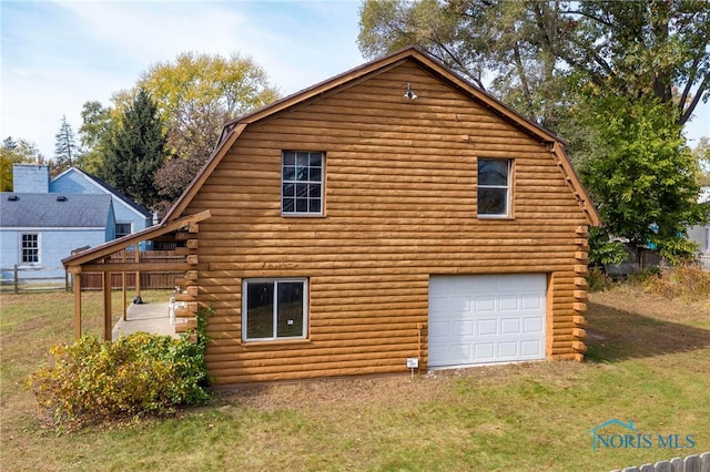 view of side of property with a garage and a lawn