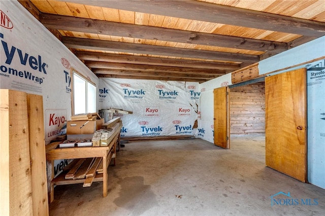 basement with wood ceiling and wood walls