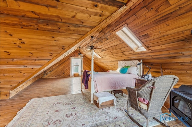 unfurnished bedroom with lofted ceiling with skylight, wood ceiling, light wood-type flooring, and wood walls