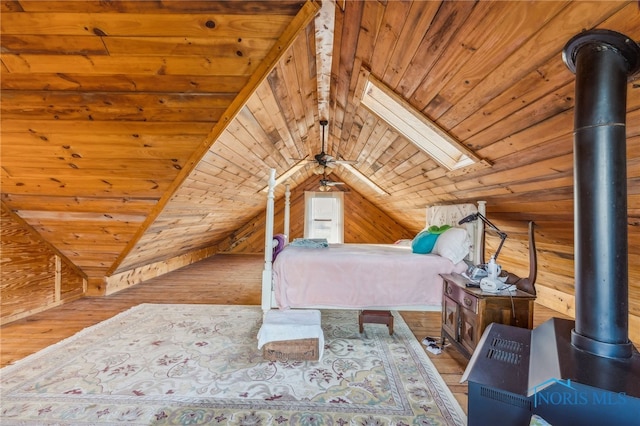 unfurnished bedroom featuring wooden walls, vaulted ceiling with skylight, wood ceiling, and light wood-type flooring