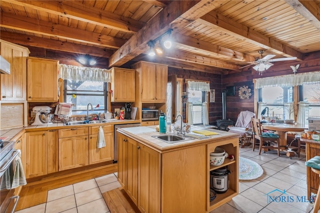 kitchen featuring a wealth of natural light, tile counters, wooden ceiling, and wood walls