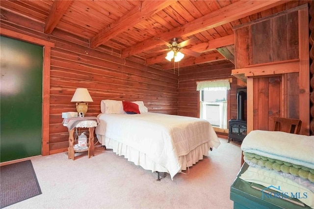 carpeted bedroom featuring wooden walls, wood ceiling, beamed ceiling, and a wood stove