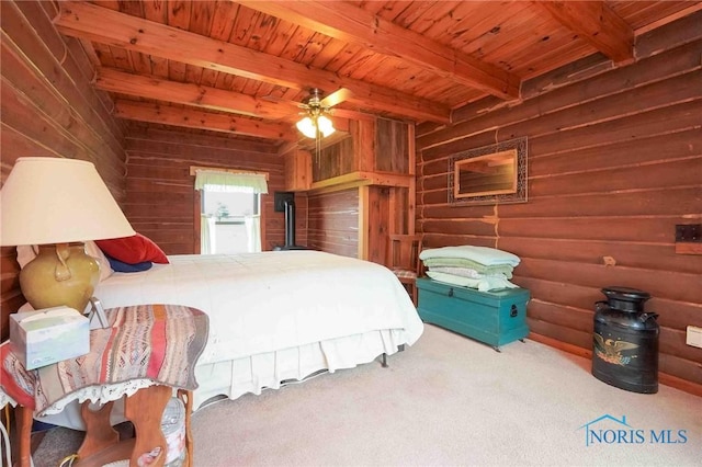 bedroom with wood walls, wooden ceiling, beam ceiling, and carpet