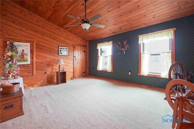 sitting room with carpet flooring, ceiling fan, a healthy amount of sunlight, and wood ceiling