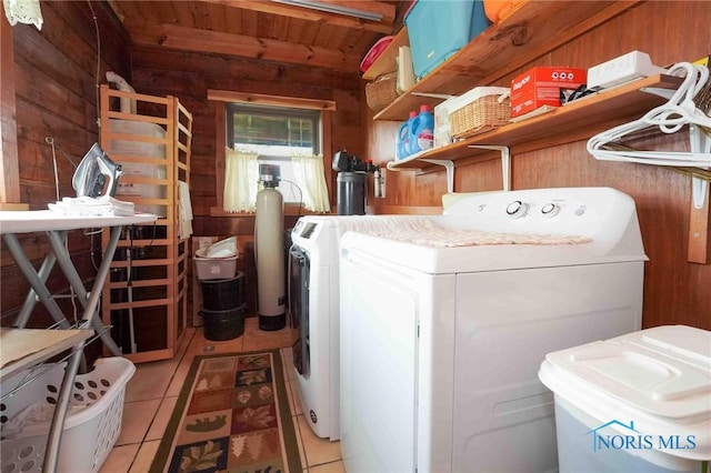 laundry room with laundry area, wood walls, washer and clothes dryer, wood ceiling, and light tile patterned floors