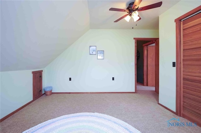 additional living space featuring carpet floors, a ceiling fan, baseboards, and vaulted ceiling