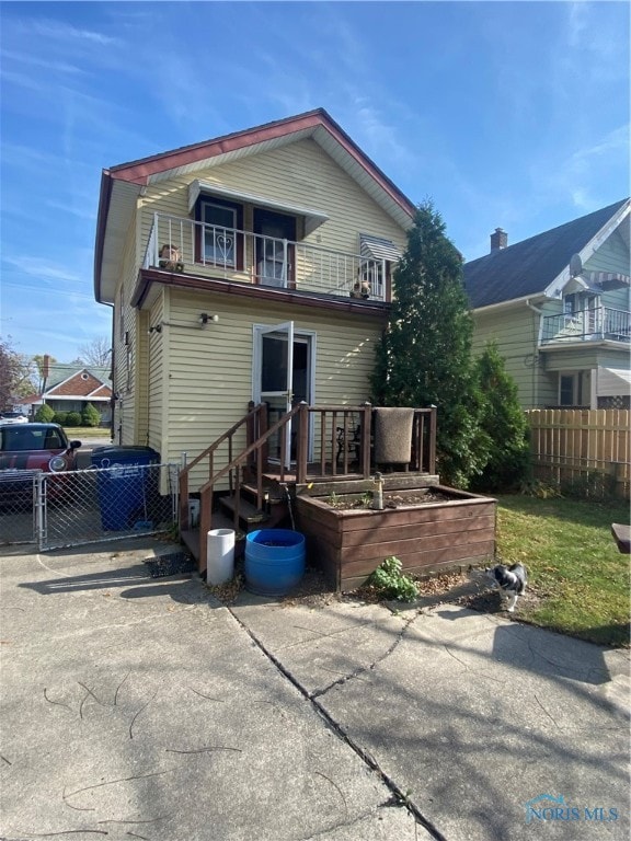 back of property with a balcony