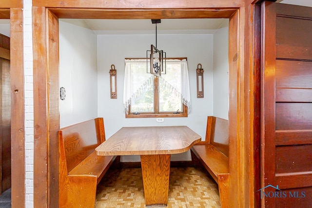 dining room featuring parquet floors and breakfast area