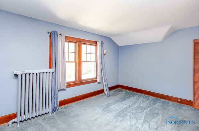 bonus room with vaulted ceiling, radiator heating unit, and carpet flooring