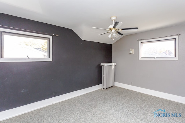 additional living space featuring ceiling fan, carpet, and vaulted ceiling