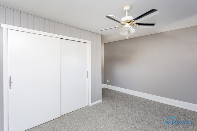 unfurnished bedroom featuring carpet flooring, a closet, and ceiling fan