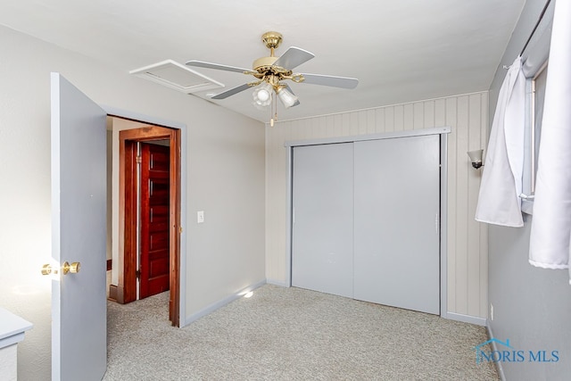 unfurnished bedroom featuring a closet, ceiling fan, and light colored carpet