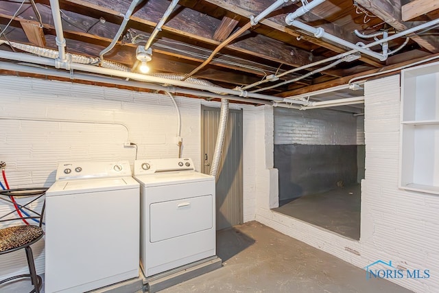 clothes washing area with washer and dryer