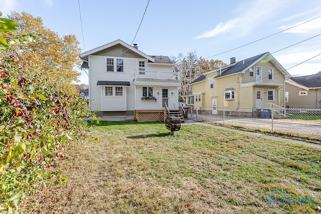 back of property featuring a yard