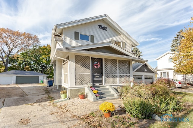 view of front of home with a porch, an outdoor structure, and a garage