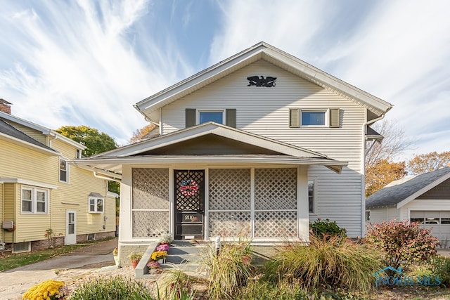 view of front of house with covered porch and a garage