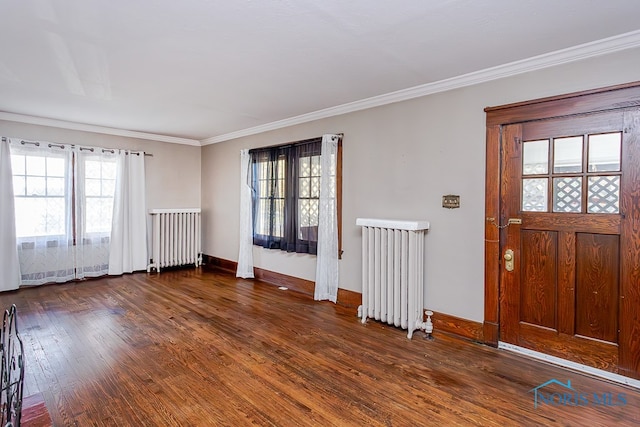 entrance foyer with crown molding, radiator heating unit, and dark hardwood / wood-style flooring