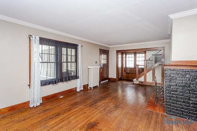 living room with crown molding, radiator heating unit, and dark hardwood / wood-style flooring