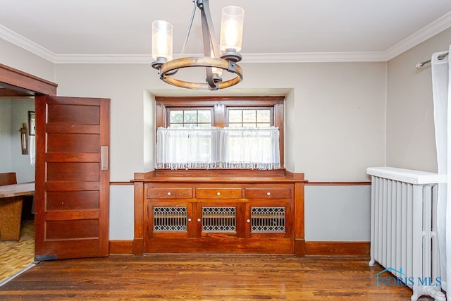 unfurnished dining area featuring a notable chandelier, radiator heating unit, crown molding, and dark hardwood / wood-style flooring