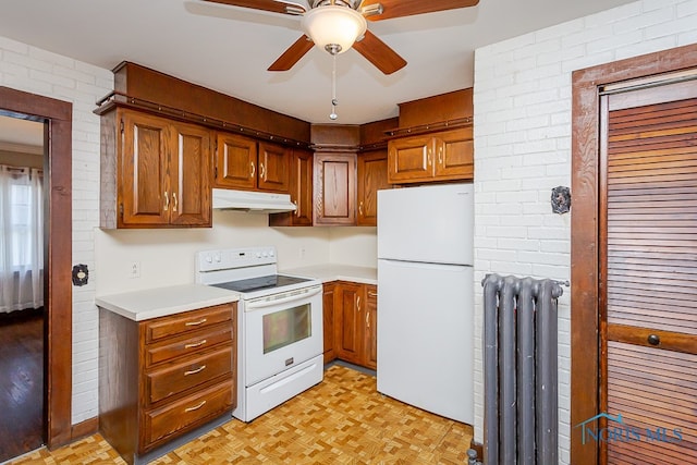 kitchen with ceiling fan, light parquet flooring, radiator, and white appliances