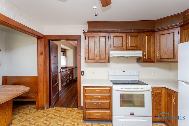 kitchen featuring light hardwood / wood-style floors, ceiling fan, and white appliances