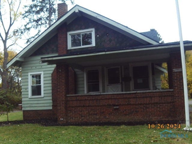 view of side of property featuring a porch