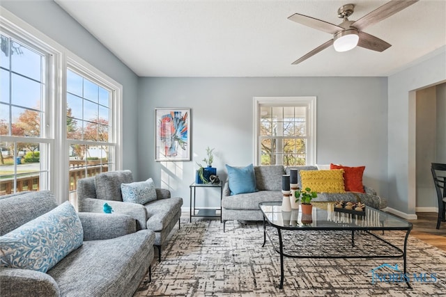 living room featuring a wealth of natural light, hardwood / wood-style flooring, and ceiling fan