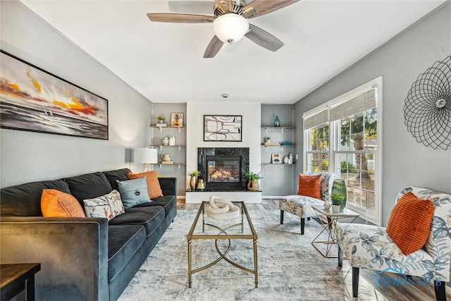 living room featuring light wood-type flooring and ceiling fan