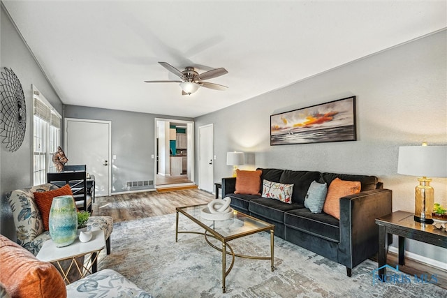 living room featuring ceiling fan and wood-type flooring