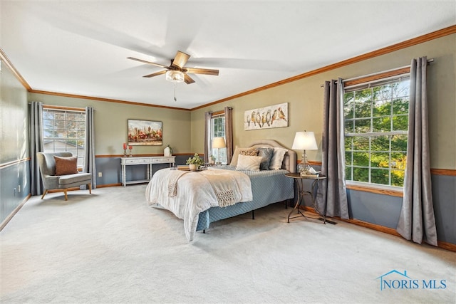 bedroom with carpet flooring, ceiling fan, and crown molding