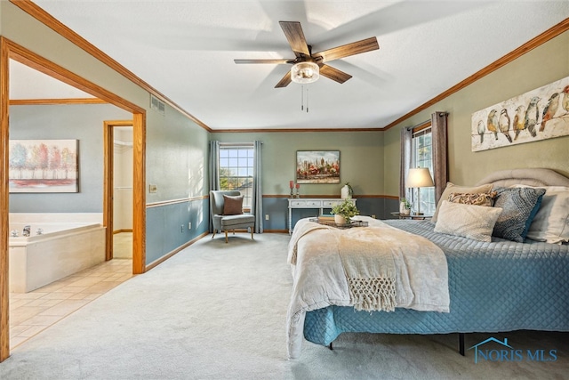 carpeted bedroom featuring ornamental molding and ceiling fan