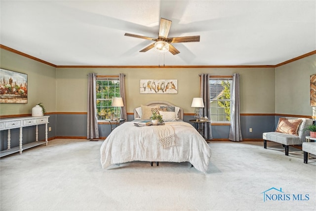 carpeted bedroom featuring ceiling fan, multiple windows, and crown molding