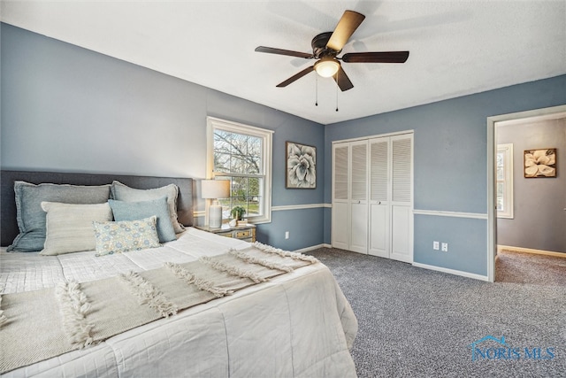 carpeted bedroom with a closet and ceiling fan