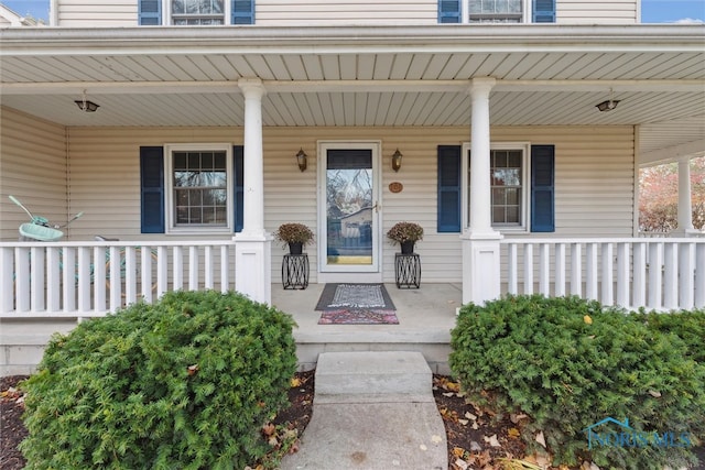 view of exterior entry with a porch