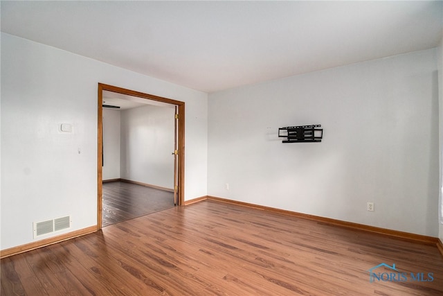 spare room with hardwood / wood-style floors