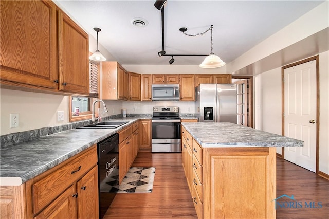 kitchen with a center island, stainless steel appliances, dark wood-type flooring, and pendant lighting