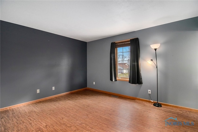 unfurnished room featuring hardwood / wood-style flooring