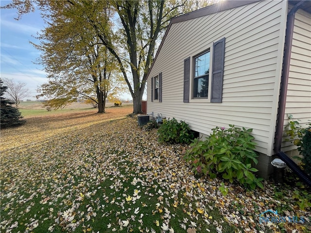 view of side of home featuring central AC unit