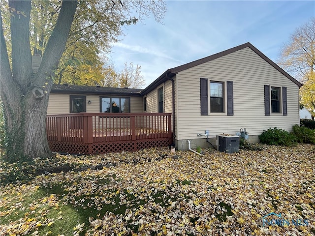 back of house with a deck and central AC