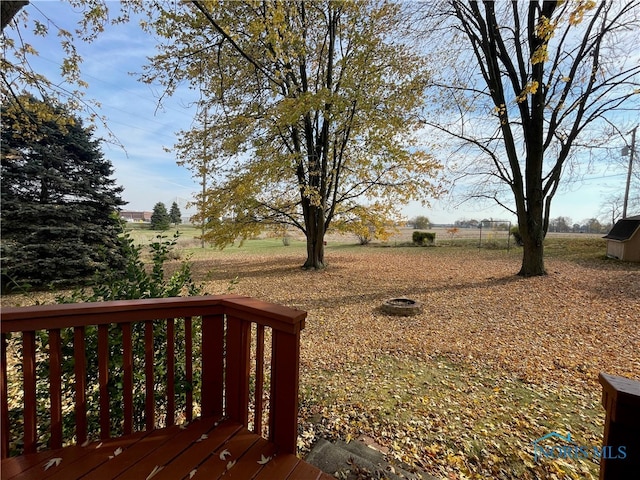 view of yard with a rural view and a deck