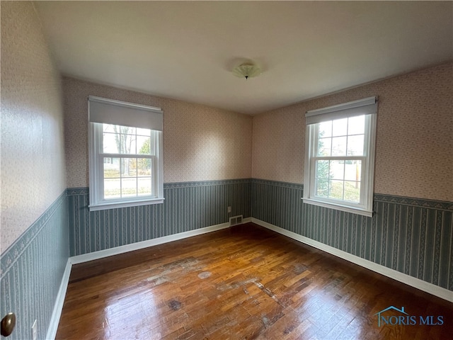 empty room featuring dark wood-type flooring