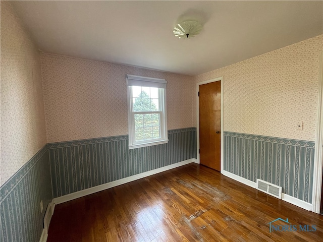 spare room with wood-type flooring