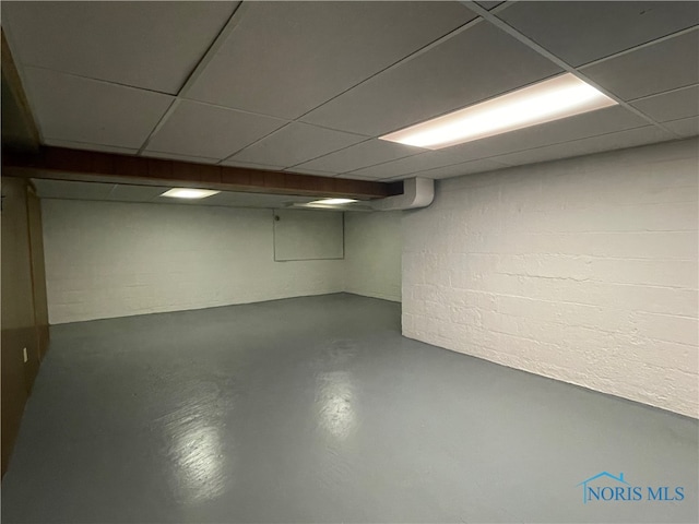 basement featuring a paneled ceiling