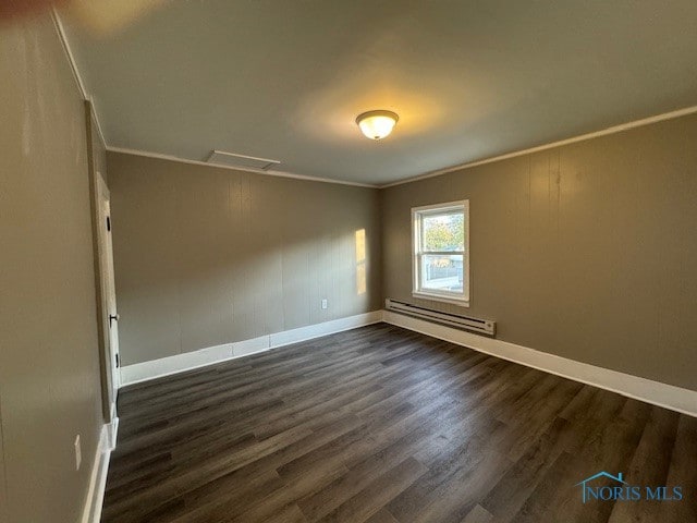 unfurnished room with baseboard heating, ornamental molding, and dark hardwood / wood-style floors