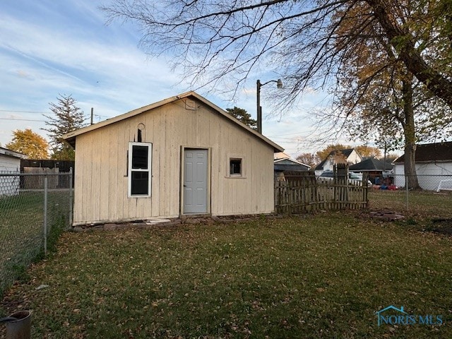 view of outdoor structure with a lawn