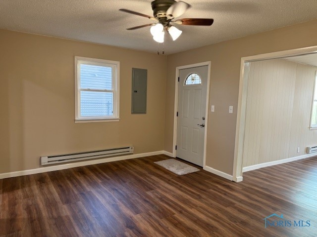 foyer with baseboard heating, electric panel, dark wood-type flooring, and ceiling fan