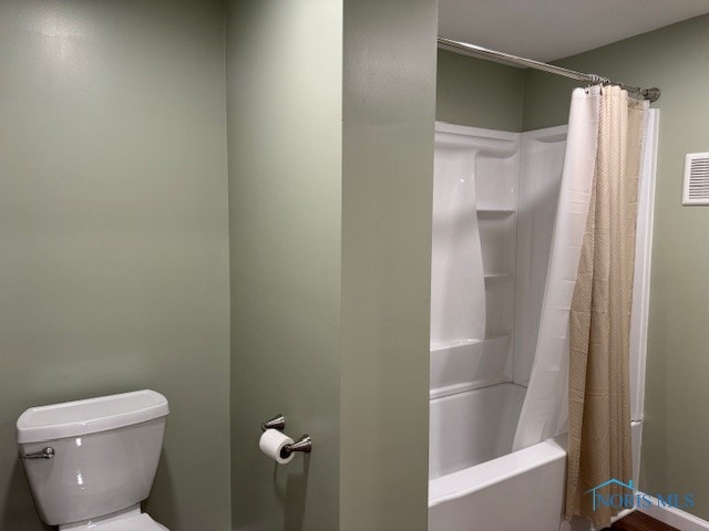 bathroom with toilet and shower / bath combo