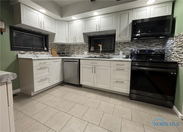 kitchen featuring white cabinets, dishwasher, tasteful backsplash, sink, and black electric range